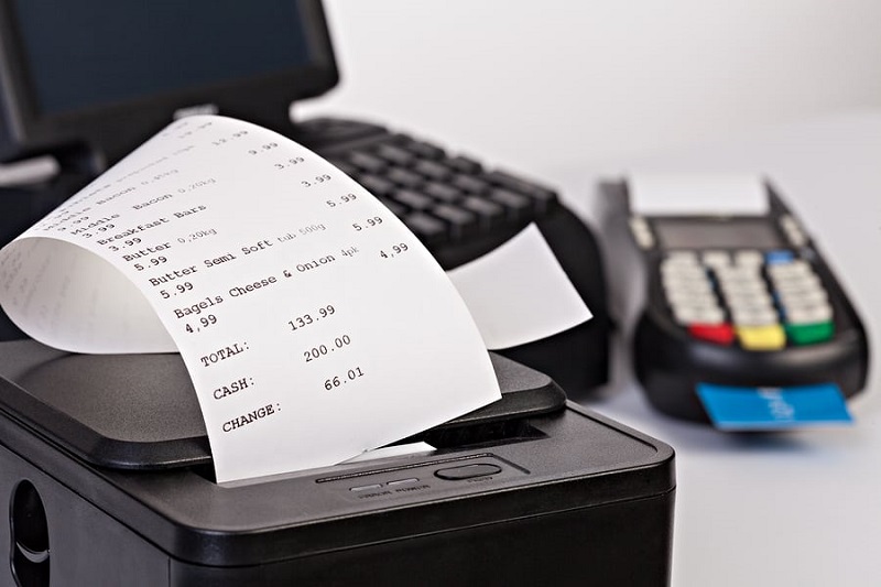 Mobile printer and pay terminal on a cash box at a counter in regular retail shop